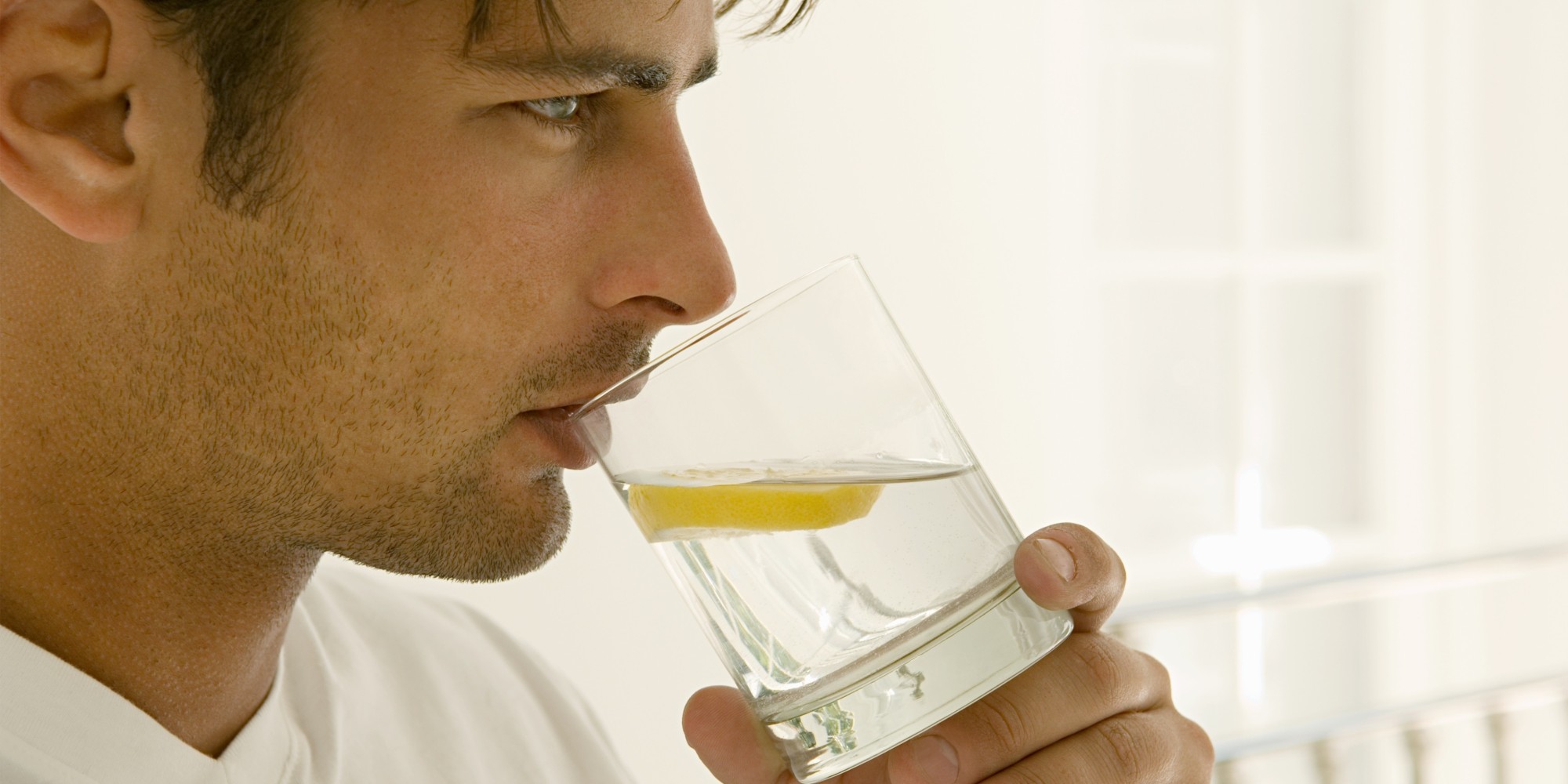 Man drinking water with lemon